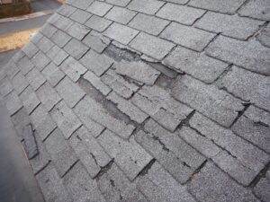 Roof repair needed by Elite Roofing & Solar. A roof with visible signs of wear and tear, indicating the need for urgent repairs in Denver, CO