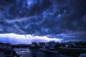 Storm clouds over a city causing storm damage.