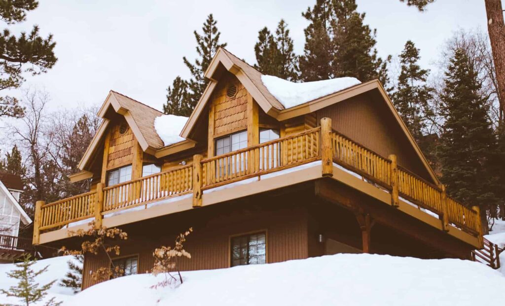 Colorado mountain house with roof covered in snow.