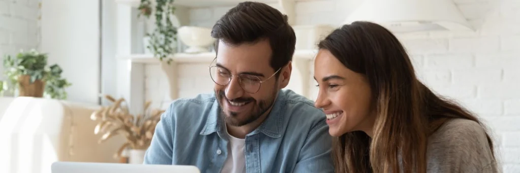 Couple studies solar tax credit eligibility details online for Denver, CO home solar project with Elite Roofing & Solar