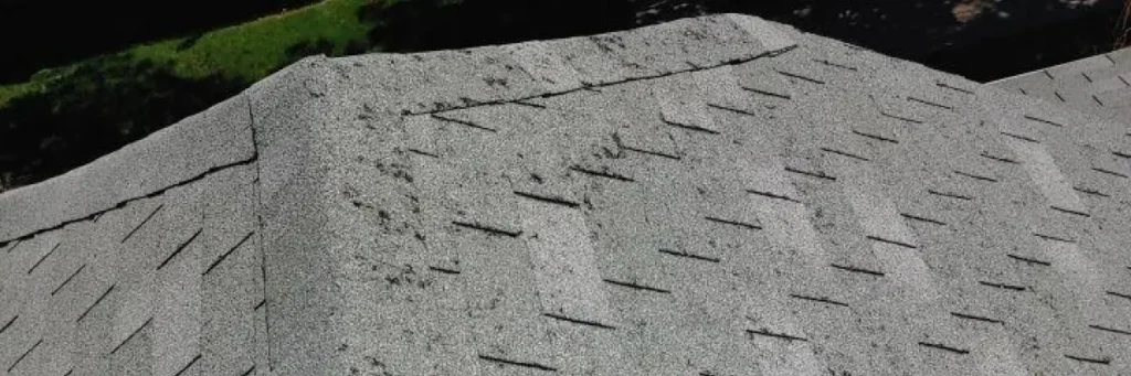 Roof with visible hail impact marks, granule loss, and scattered damage showing hail damage roof insurance claims process