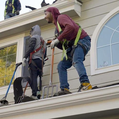 Team of professional roofers installing new shingles on a home by Elite Roofing & Solar, trusted denver roofing contractor