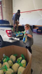 Elite Roofing & Solar staff loading Turkeys on a truck in Denver