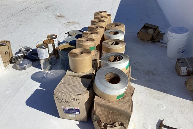 TPO commercial roofing rolls and materials organized on rooftop for installation by Elite Roofing and Solar in Greater Denver