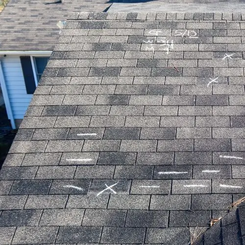 Close-up view of a Denver roof with chalk markings used for insurance claim inspection and damage assessment.