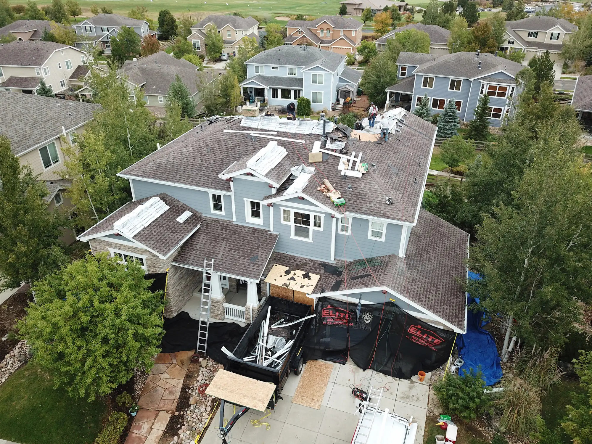 Bird’s-eye view of a new roof installation in Denver, showing roofing work in progress on a residential home.