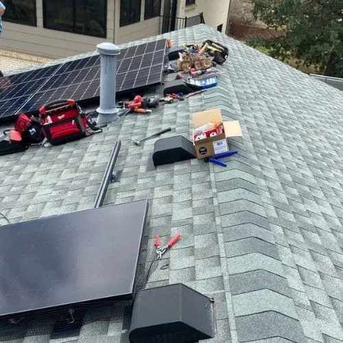 Asphalt-shingle roof with PV mounts, microinverters, and tools during install by a nabcep certified solar installer in Colorado