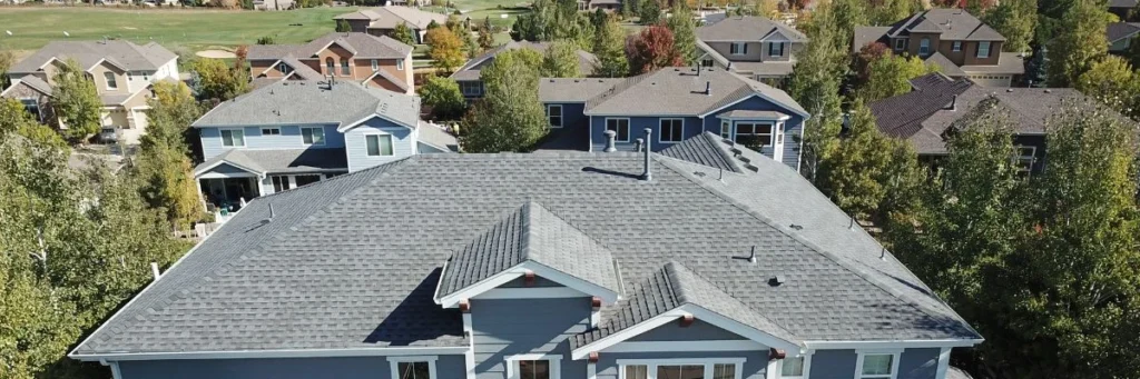 Residential shingle roofs in a suburban neighborhood, illustrating hail damage roof insurance claims process by Elite Roofing & Solar