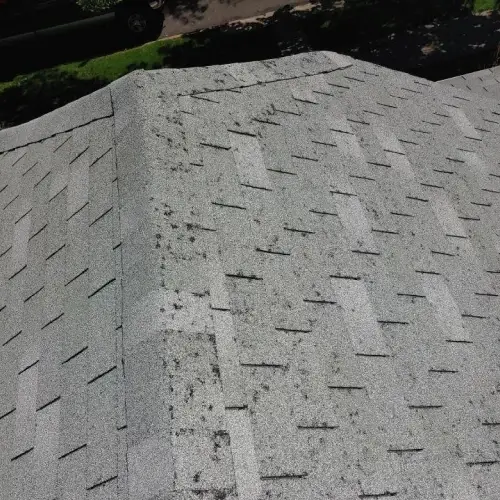 Roof with visible hail impact marks, granule loss, and scattered damage showing hail damage roof insurance claims process