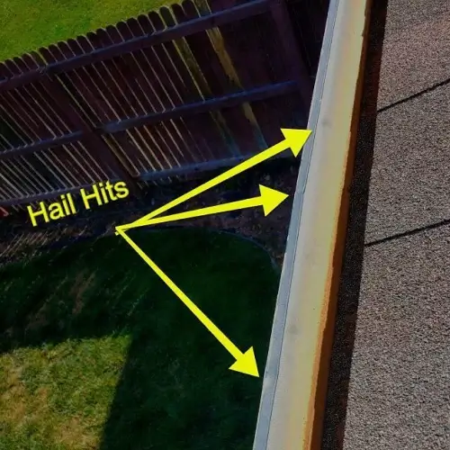 Roof edge and gutter with yellow arrows marking hail hits, demonstrating when to report hail damage on roof, provided by Elite Roofing & Solar