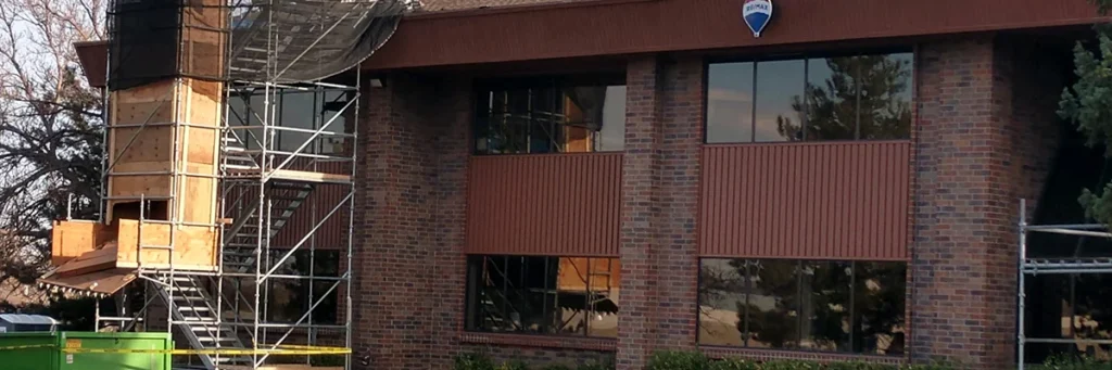 Professional roofers in Denver CO repairing a commercial building by Elite Roofing & Solar