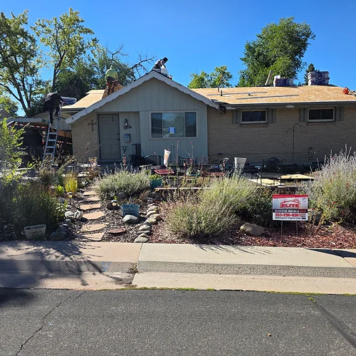 Roofing team replacing roof for community roofing project Denver by Elite Roofing & Solar in Denver