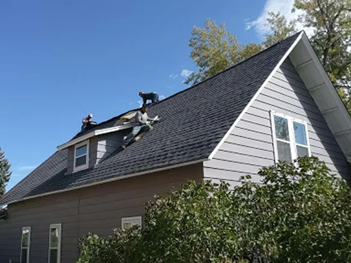 Roofing team completing residential roof replacement with new shingles by Elite Roofing and Solar in Centennial, CO