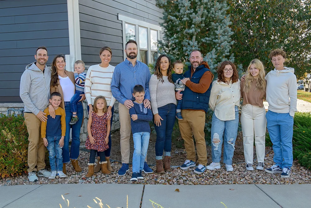 Elite Roofing & Solar team of roofers in Denver CO standing outside a residential home