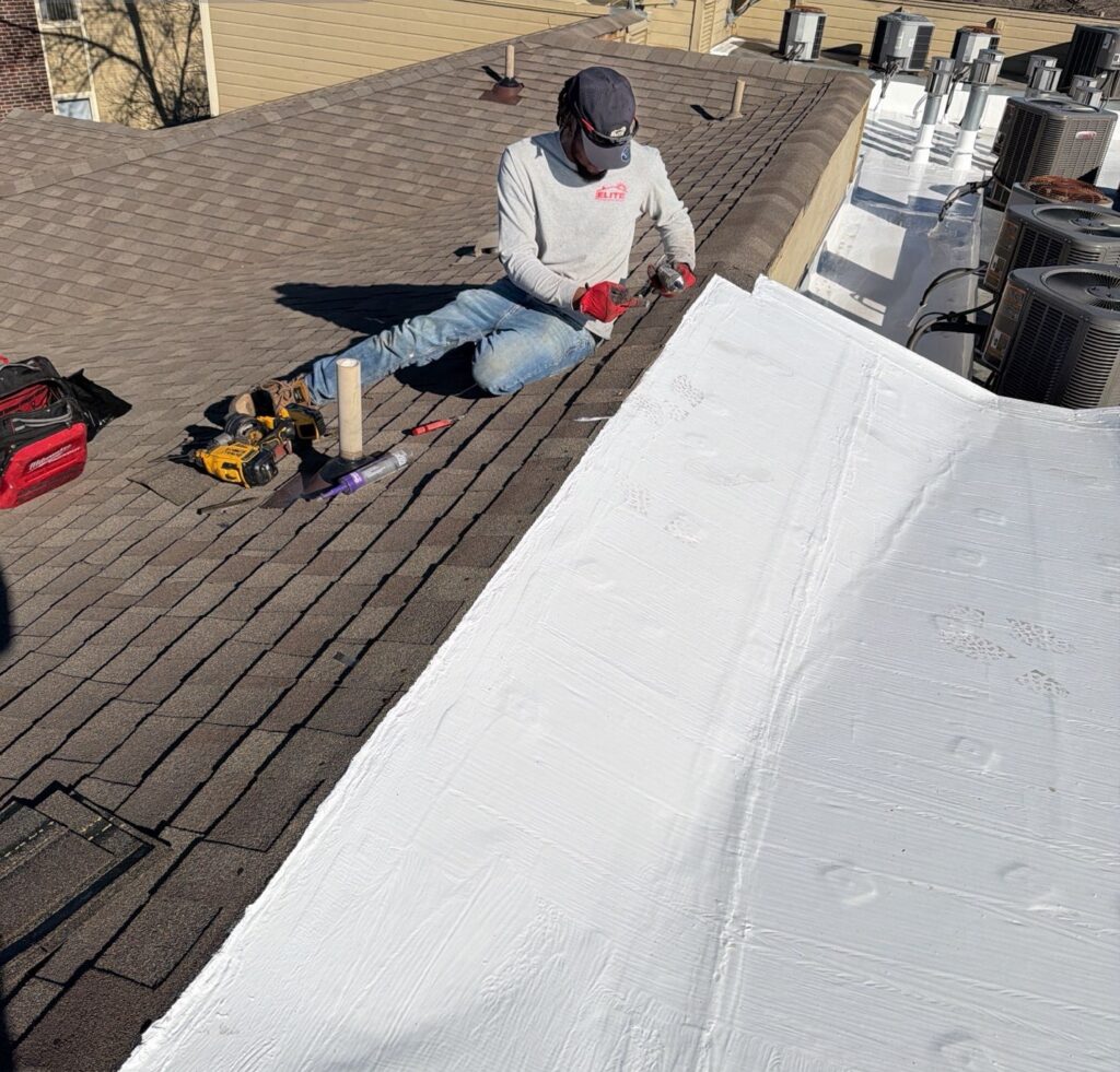Roofing technician performing roof maintenance on an asphalt shingle roof