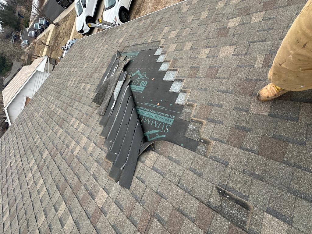 roof repair by Elite Roofing & Solar to wind blown shingles during maintenance inspection