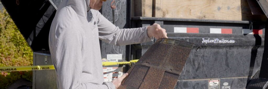 Elite Roofing & Solar pro examining asphalt shingles during a roof estimate second opinion inspection in Colorado
