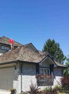 Roof inspection in progress: A roof inspector from Elite Roofing & Solar is assessing the condition of a damaged roof in Denver, CO