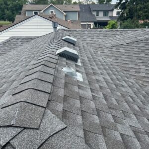 Gray asphalt shingle roof with three different types of roof vents, installed by Elite Roofing & Solar in Denver