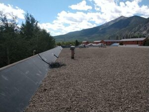 EDPM roof from rooftop with mountains in the background EPDM Roof Repair Elite Roofing & Solar in Denver, CO